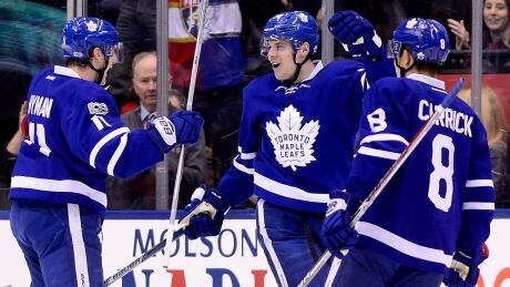 Toronto's Auston Matthews (34) celebrates his 35th goal of the season with Zach Hyman (11) and Connor Carrick (8) Tuesday night, setting a franchise record for rookies. HKN Panthers Maple Leafs 20170328