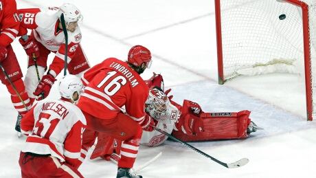 Carolina Hurricanes' Elias Lindholm (16) scores against Detroit Red Wings goalie Jimmy Howard during the third period. red-wings-hurricanes