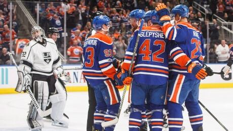 Los Angeles Kings goalie Jonathan Quick (32) looks on as the Edmonton Oilers celebrate a goal during second period. kings-oilers