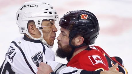 Los Angeles Kings' Jarome Iginla, left, fights with Calgary Flames' Deryk Engelland during first period. kings-flames