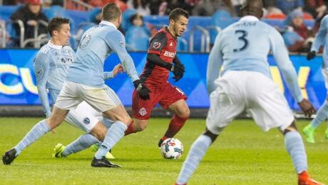 Toronto FC's Sebastien Giovinco, centre, tries to find a way around the Sporting Kansas City defence during their 0-0 draw Friday in Toronto. SOC Kansas City Toronto 20170331