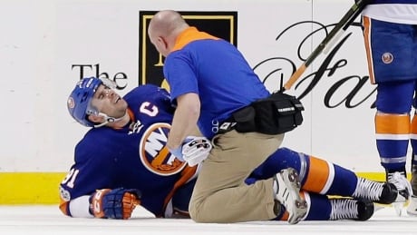 A trainer checks on New York Islanders centre John Tavares after he was injured during the third period against the New Jersey Devils on Friday. tavares-john-033117-620