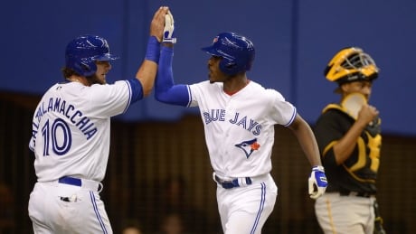 Toronto Blue Jays outfielder Melvin Upton Jr. rates his two-run home run with teammate Jared Saltalamacchia as Pittsburgh Pirates' catcher Elias Diaz looks on during fourth inning in Montreal on Saturday. blue-jays-040117-620