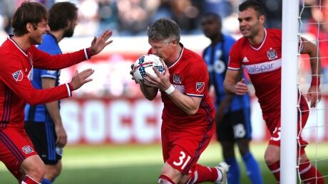 Chicago Fire midfielder Bastian Schweinsteiger (31) kisses the ball after scoring a goal in the first half of a game against the Montreal Impact. impact-fire