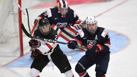 Canada's Meghan Agosta vies for position with the United State's Monique Lamoureux during the first period of a 2-0 loss to the U.S. in the opener of the women's world hockey championship action in Plymouth, Mich., on Friday. canada-us-womens-hockey-