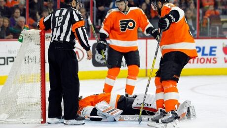 Philadelphia Flyers goalie Michal Neuvirth lies prone on the ice after collapsing early in the first period against the New Jersey Devils on Saturday. neuvirth-michal-040117-620