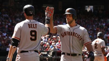 San Francisco Giants pitcher Madison Bumgarner, right, celebrates after hitting a solo home run on opening day against the Arizona Diamondbacks. Bumgarner-Madison-04022017