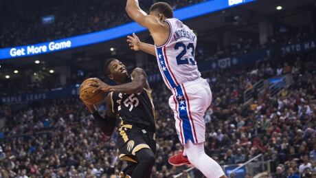 Toronto Raptors guard Delon Wright (55) drives into Philadelphia 76ers guard Justin Anderson (23) during first half. raptors-76ers