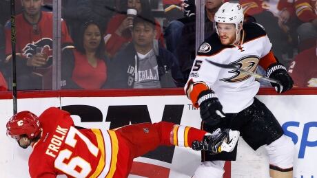 Anaheim Ducks' Korbinian Holzer, right, knocks down Calgary Flames forward Michael Frolik in the Ducks' 4-3 victory on Sunday. Holzer-Korbinian-04022017