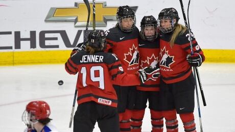 Canada's Erin Ambrose (23) celebrates with teammates after she scored a second period goal against Russia. canada-russia