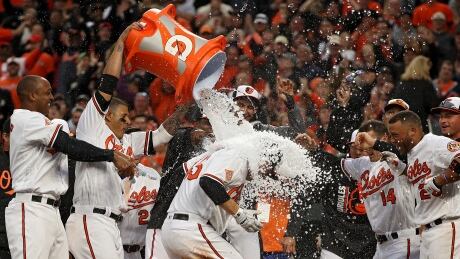 Mark Trumbo of the Baltimore Orioles is greeted at home plate after hitting a walk-off home run against the Toronto Blue Jays in Monday's 3-2 11-inning win. trumbo-mark