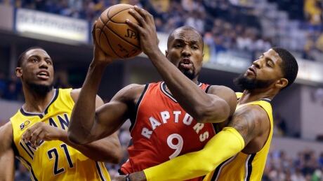 Indiana Pacers forward Paul George (13) fouls Toronto Raptors forward Serge Ibaka (9) during the first half of a game in Indianapolis. raptors-pacers