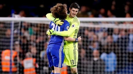 Chelsea's goalkeeper Thibaut Courtois, right, embraces his teammate David Luiz, left, after the match between Chelsea and Manchester City. chelsea-manchester