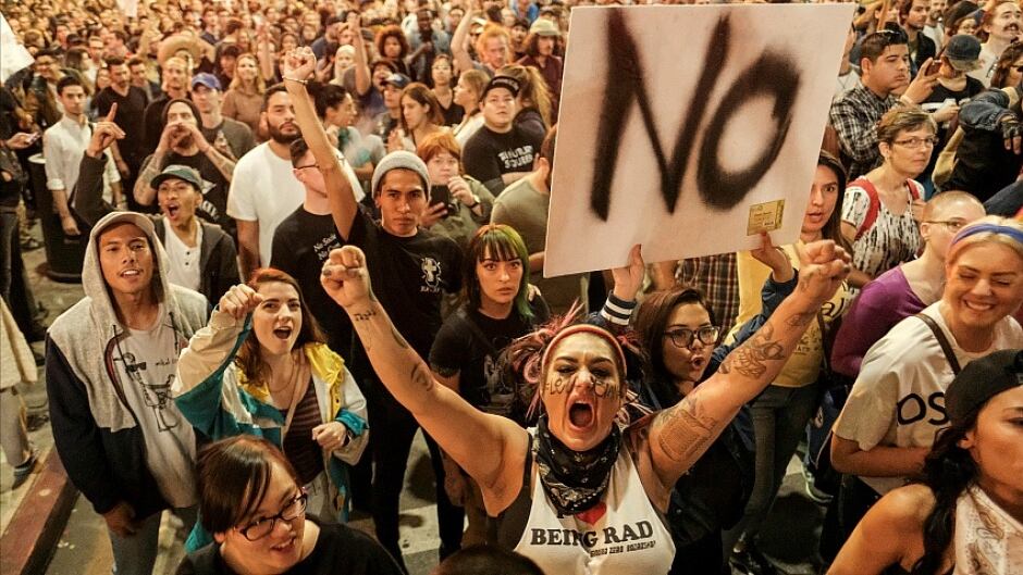 Demonstrators gather to protest a day after President-elect Donald Trump's victory, at a rally outside Los Angeles City Hall on November 9, 2016.