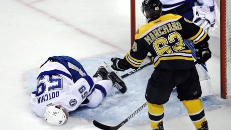 Lightning defenceman Jake Dotchin lies on the ice after Bruins forward Brad Marchand speared him late in the first period of Tuesday night's matchup. Marchand was assessed a five-minute major and game misconduct and on Thursday the NHL suspended him two games. marchand-brad-170404-1180
