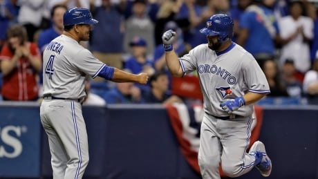 Toronto Blue Jays' Kendrys Morales, right, high fives third base coach Luis Rivera after hitting a grand slam off Tampa Bay Rays starting pitcher Blake Snell during the third inning on Thursday in St. Petersburg, Fla. morales-kendrys-040617-620