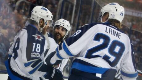 Winnipeg Jets' Bryan Little, left, had a goal and three assists in Winnipeg's 5-4 win over the Columbus Blue Jackets. winnipeg-jets