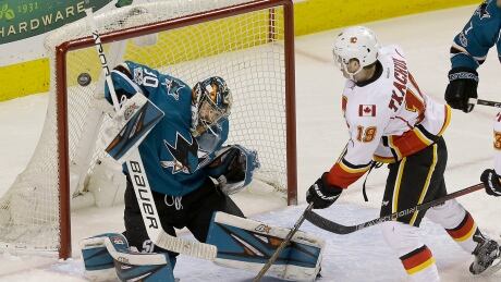 Calgary Flames forward Matthew Tkachuk, right, watches San Jose Sharks' Aaron Dell make a save during the first period on Saturday. Dell-Aaron-04082017