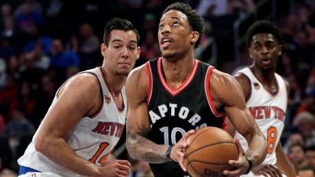 Toronto's DeMar DeRozan, centre, poured in 35 points against New York on Sunday. Raptors Knicks Basketball