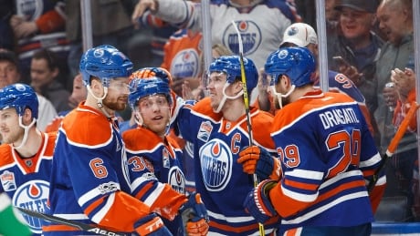 Edmonton's Drake Caggiula (36) celebrates a goal with teammates Adam Larsson (6), Connor McDavid (97) and Leon Draisaitl (29) during the Oilers' 5-2 win over the Vancouver Canucks on Sunday. Oilers-Canucks-09042017