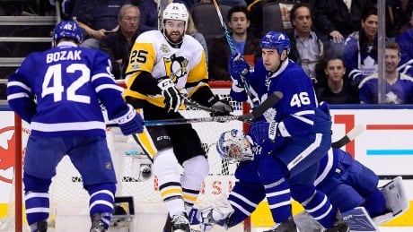 Penguins left-winger Tom Sestito (25) picks up a penalty for interfering with Maple Leafs goalie Frederik Andersen (31) as teammates Tyler Bozak (42) and Roman Polak (46) look on during an April 8 game in Toronto. andersen-frederik-170408-1180