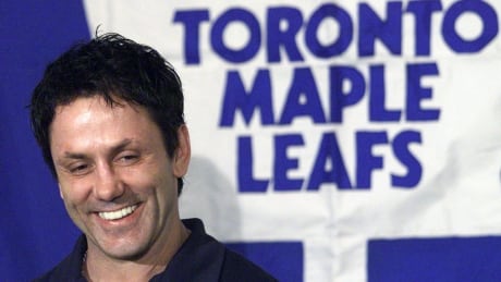 Newly acquired Toronto Maple Leafs' Doug Gilmour smiles as he answers questions at a news conference after arriving in Calgary, Wednesday March 12, 2003. The Maple Leafs are in town to play the Calgary Flames Thursday. (CP PHOTO/Adrian Wyld) gilmour-doug-1180