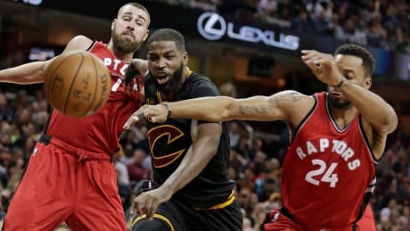 Toronto Jonas Valanciunas, left, and Norman Powell, right, battle Cleveland's Tristan Thompson during the Raptors' 98-83 win in their final game of the regular season Wednesday. Raptors Cavaliers Basketball