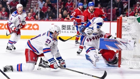 New York goaltender Henrik Lundqvist makes one of his 31 saves in a 2-0 shutout of the Montreal Canadiens on Wednesday. 95320901