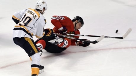Chicago's Artem Anisimov falls as Nashville's Calle Jarnkrok defends during the Predators' 1-0 win Thursday in Chicago. Predators Blackhawks Hockey