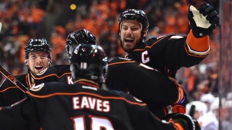 Ryan Getzlaf, right, celebrates after scoring a power-play goal in the Ducks' 3-2 win over the Flames. Getzlaf Ducks Flames Game 1