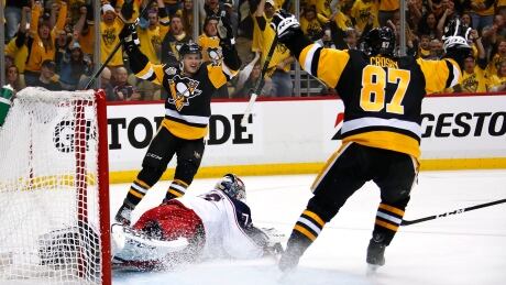 Sidney Crosby, right, celebrates after setting up Jake Guentzel during Pittsburgh's win over Columbus. crosby-sidney-041417-620