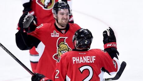 Ottawa Senators defenceman Dion Phaneuf is congratulated by teammate Mark Stone after his goal during overtime against the Boston Bruins in Ottawa on Saturday. April 15, 2017. THE CANADIAN PRESS/ senators-phaneuf-041516-620