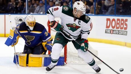 Minnesota Wild's Mikko Koivu tries to control the puck as St. Louis Blues goalie Jake Allen defends during the third period. wild-blues