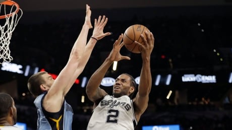 San Antonio's Kawhi Leonard, right, shoots over Memphis' Marc Gasol during the Spurs' Game 2 win Monday night. Grizzlies Spurs Basketball
