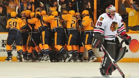 NASHVILLE, TN - APRIL 17: Kevin Fiala #56 of the Nashville Predators is swarmed by teammates after scoring the game winning overtime goal against goalie Corey Crawford #50 of the Chicago Blackhawks in Game Three of the Western Conference First Round during the 2017 NHL Stanley Cup Playoffs at Bridgestone Arena on April 17, 2017 in Nashville, Tennessee. (Photo by Frederick Breedon/Getty Images) predators-celebrate-170417-1180