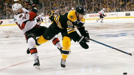 Boston Bruins' David Pastrnak gets tangled up with Ottawa's Viktor Stalberg in the second period of Game 3. Boston will try to claw back into the best-of-seven series on Wednesday after falling behind 2-1. bruins-senators