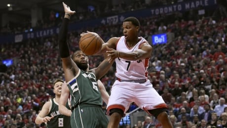 Toronto Raptors guard Kyle Lowry (7) passes away from Milwaukee Bucks centre Greg Monroe (15) during first half in Toronto. bucks-raptors