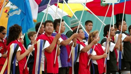 Placard and flag carriers represent provinces and states from all over North America during opening ceremonies of the North American Indigenous Games in Winnipeg, Man., 2002. GAMES-INDIGENOUS