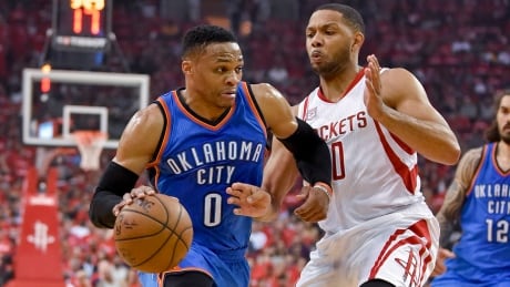 Oklahoma City Thunder guard Russell Westbrook (0) drives past Houston Rockets guard Eric Gordon during the first half of Wednesday's Game 2. thunder-rockets
