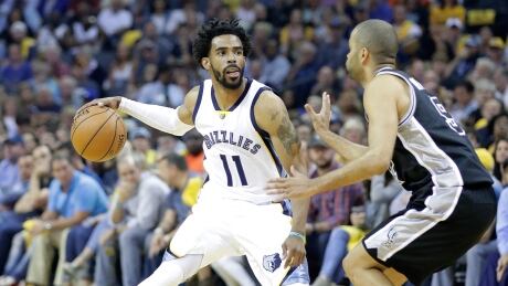 Grizzlies guard Mike Conley, left, guided his team to a resounding win over the Spurs on Thursday. 95415397