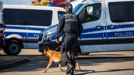 A police officer walks with a dog in Rottenburg am Neckar, southern Germany on Friday, where a suspect was arrested in connection to the bombing of Borussia Dortmund's team bus the week before. Germany-Dortmund-Attack