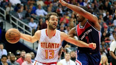 Atlanta's Jose Calderon drives past Washington's John Wall during the Hawks' 111-101 Game 4 win Monday night. 95481988