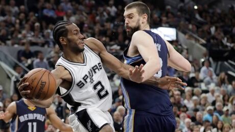 San Antonio Spurs forward Kawhi Leonard (2) passes the ball around Memphis Grizzlies centre Marc Gasol (33) during the second half. leonard-kawhi