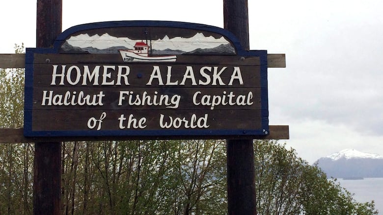 A sign that says Homer, Alaska 