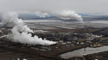 Aerial view of the Syncrude oil sands extraction facility with the Suncor extraction facility in the background, near Fort McMurray on October 23, 2009. Oil Sands Emissions