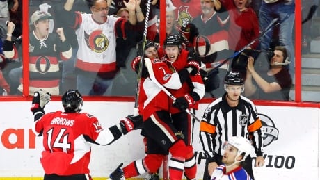 Ottawa's Ryan Dzingel (18) celebrates his goal with teammates Kyle Turris (7) and Alex Burrows (14) during the Senators's 2-1 win in Game 1 Thursday. HKN Rangers Senators 20170427
