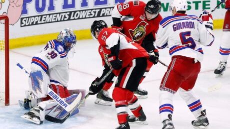 Ottawa's Tommy Wingels (57) shoots on New York Rangers goalie Henrik Lundqvist while teammate Ryan Dzingel (18) looks for a rebound during the Senators' 2-1 Game 1 win Thursday. Senators-Rangers-27-04-2017