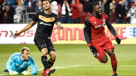 Toronto FC's Jozy Alitdore, right, celebrates one of his two goals as Houston's Joe Willis, left, and Juan Cabezas react during FC's 2-0 win Friday in Toronto. SOC MLS Houston Toronto 20170428