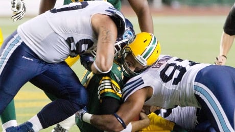 Canadian defensive tackle Cleyon Laing, left, seen playing for the Toronto Argonauts in 2013, is returning to the team for the 2017 season. laing-cleyong-092813-620