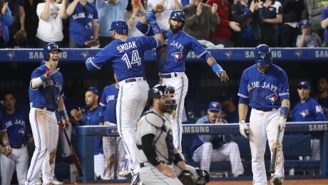 Toronto Blue Jays first baseman Justin Smoak is congratulated by Jose Bautista after hitting a two-run home run in the sixth inning to give the Blue Jays a 4-1 lead over the Tampa Bay Rays at Rogers Centre on Saturday in Toronto. blue-jays-042917-620